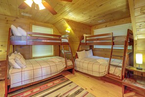 A cabin with two bunk beds, wooden walls, and a ceiling fan. - Hot Tub, Fire Pit, Views & More: Blowing Rock Gem (Blowing Rock)