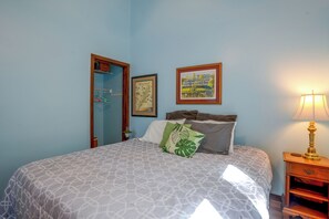 A bedroom with a bed, a nightstand, a lamp, a framed map, and a door with a mirror. - 2 Mi to Bryce Resort! All-season Condo w/ Views (Basye)