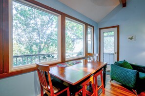 A room with a wooden dining table, chairs, and a green cushioned sofa. - 2 Mi to Bryce Resort! All-season Condo w/ Views (Basye)