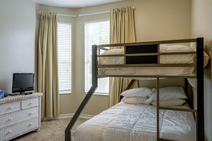A bunk bed room with a television on a dresser, beige curtains, and a window with blinds. - Resort Perks! Family Condo 4 Mi to Disney World! (Kissimmee)