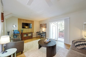 A living room with a flat-screen TV, a dining table with chairs, a sofa, a lamp, and a large window. - Duplex 6 Miles to Downtown Augusta (North Augusta)