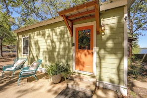A small house with a porch, a wooden door, and a window. - Fishing Cabin on Lake Bob Sandlin (Leesburg)