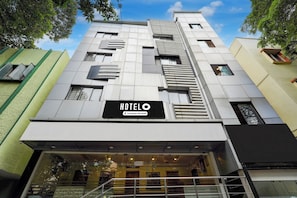 A modern hotel building with a prominent 'HOTEL' sign, large windows, and a visible entrance. - Hotel O Thimmaiah Rd Rajajinagar (Bangalore)
