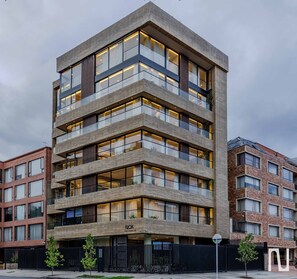 A multi-story building with a modern architectural design, featuring balconies and large windows. - NOK Bright 1BR Stay in North Bogota (Bogotá)