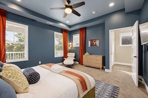 A bedroom with a bed, a desk, a chair, and a television. - Retro Retreat Hot Tub Firepit Near Lucas Oil (Indianapolis)