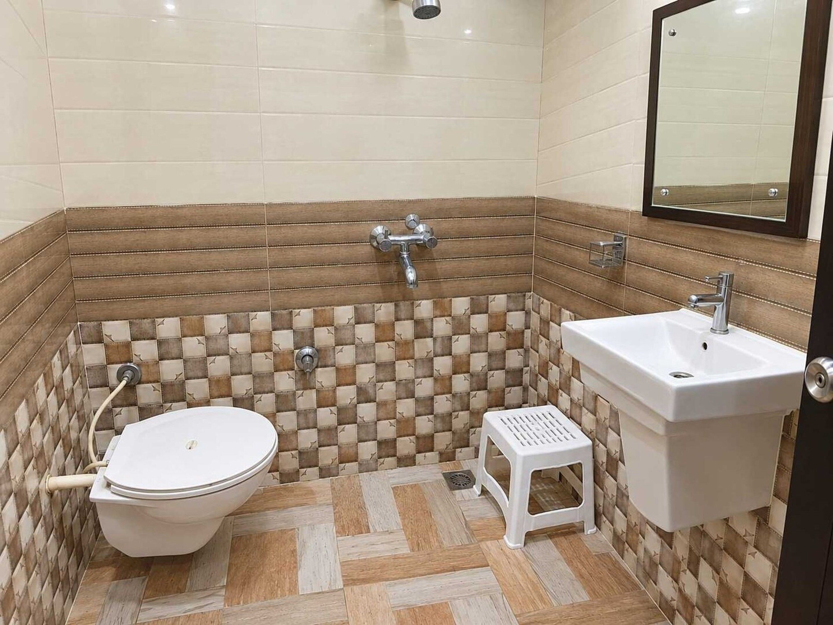 A bathroom with a toilet, sink, and shower.