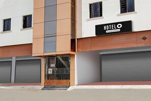 A hotel building with a sign reading 'HOTELO Company-Serviced'.