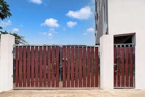 A gated entrance with a metal gate and a building entrance. - Hotel O SWEDHA HOTEL (Hazaribagh)
