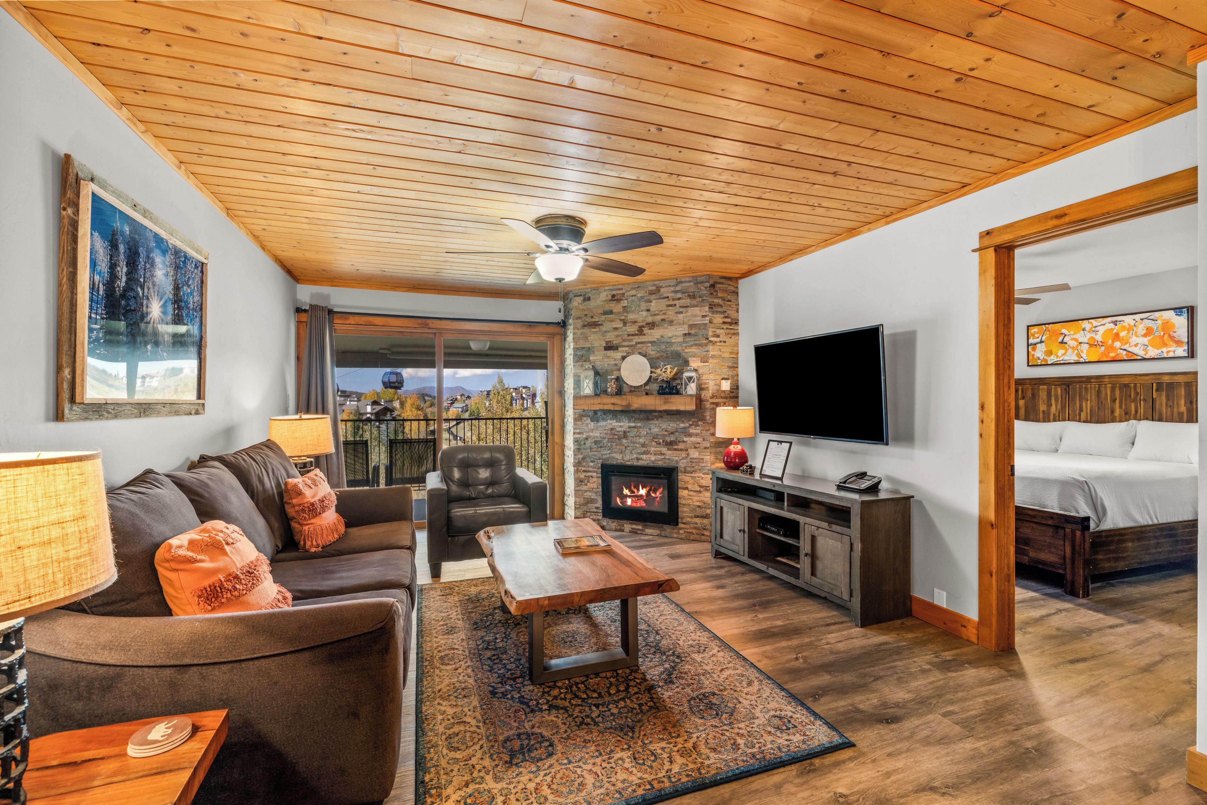 A living room with a fireplace, a television, and a sofa.