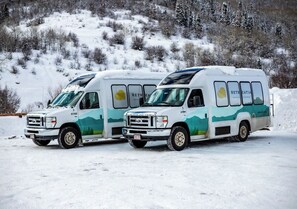 Two white vans with 'RECREATION' text and a mountain design parked on a snow-covered surface. - Spacious ski retreat with a den bunk room, just minutes from the slopes and Wild (Steamboat Springs)