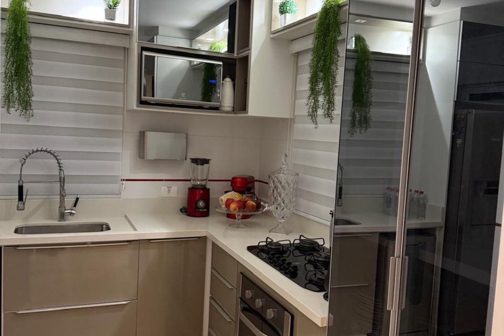 A modern kitchen with a built-in microwave, a gas stove, and a sink.