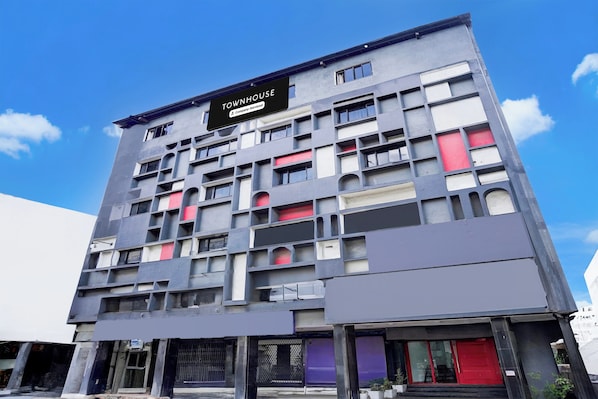 A multi-story building with a sign indicating it is a serviced company property.