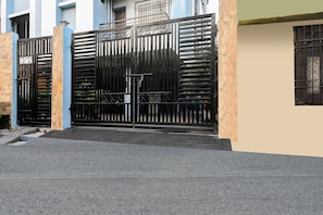 A gated entrance with a metal gate, steps leading up to a building, and a clear sky. - Hotel O Raipur City Center (Raipur)