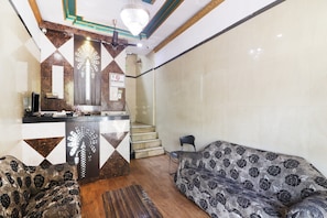 A hotel lobby with a reception desk, a staircase, a sofa, and a chandelier. - Hotel O by OYO Aadaab (Hyderabad)