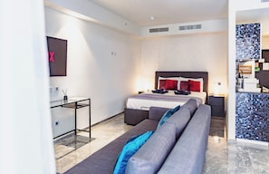A modern hotel room with a bed, a sofa, a desk, and a bathroom. - Mercury Suites Luxe Living, Pool Access (St. Julian's)