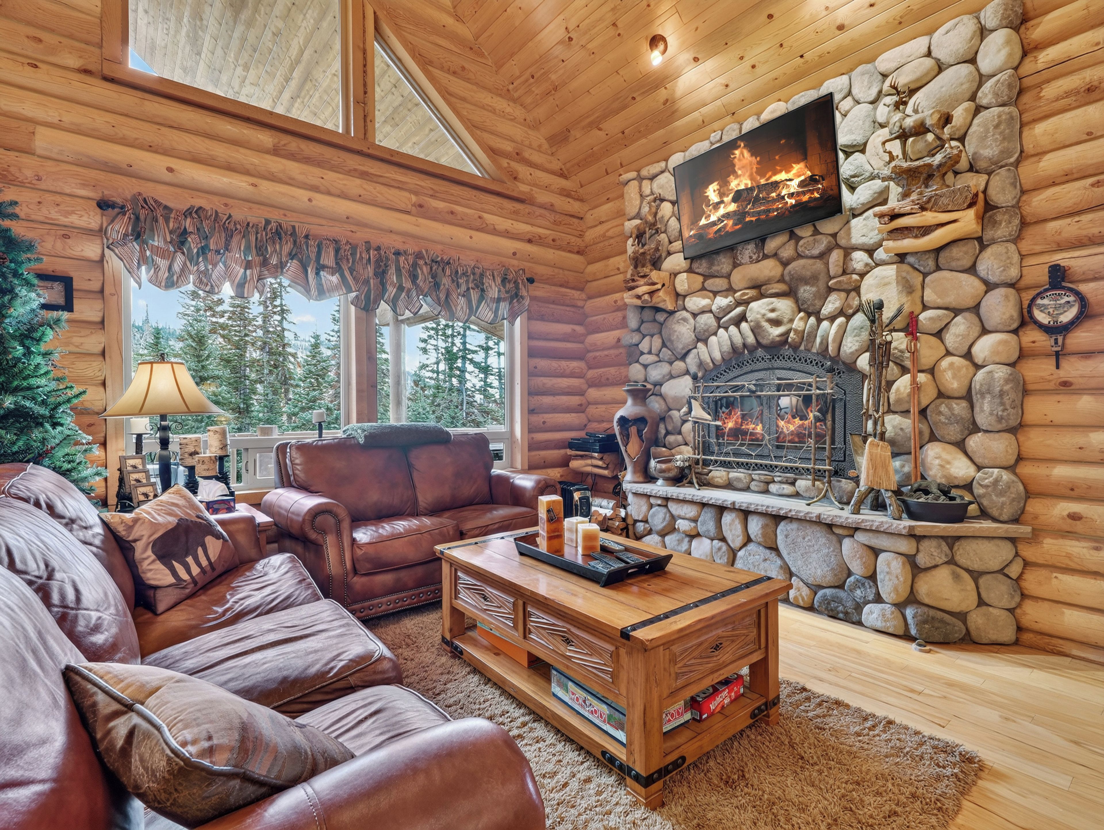 A cozy cabin interior with a stone fireplace, leather furniture, and a Christmas tree.