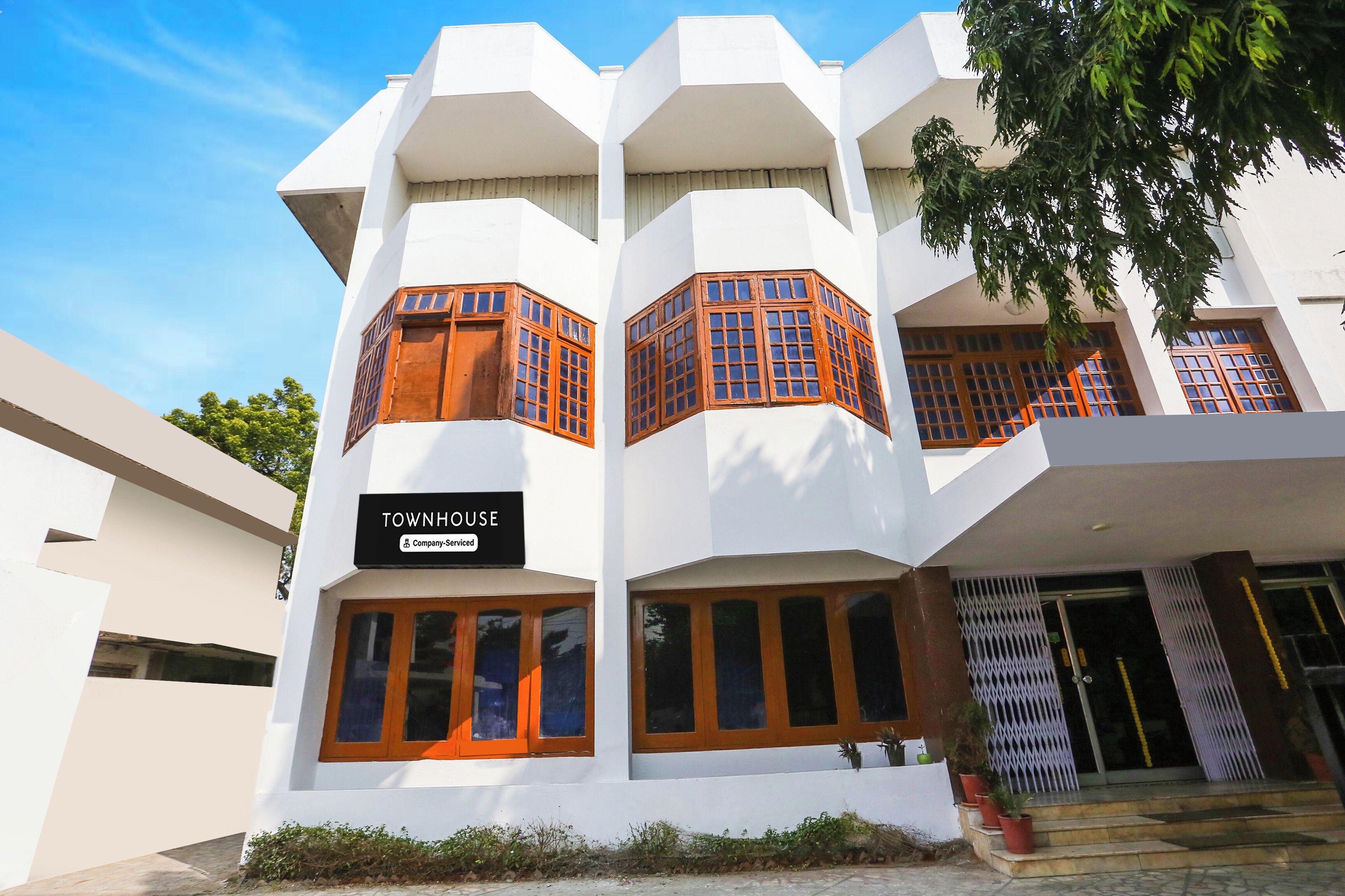 A multi-story building with a sign indicating it is a serviced company property.