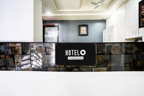A reception area with a sign that reads 'HOTEL' and 'Company-Serviced.' - Hotel O Nashik Road (Nashik)