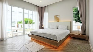A modern bedroom with a large bed, a view of greenery outside, and a window with curtains. - Ellieriviera Pool Villa ชะอำ-หัวหิน
Private Retreat 
บ้านพักส่วนตัว (Tambon Huai Sai Nuea)
