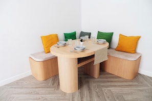 A wooden dining table with benches, set with plates, glasses, and cutlery. - Ellieriviera Pool Villa ชะอำ-หัวหิน
Private Retreat 
บ้านพักส่วนตัว (Tambon Huai Sai Nuea)