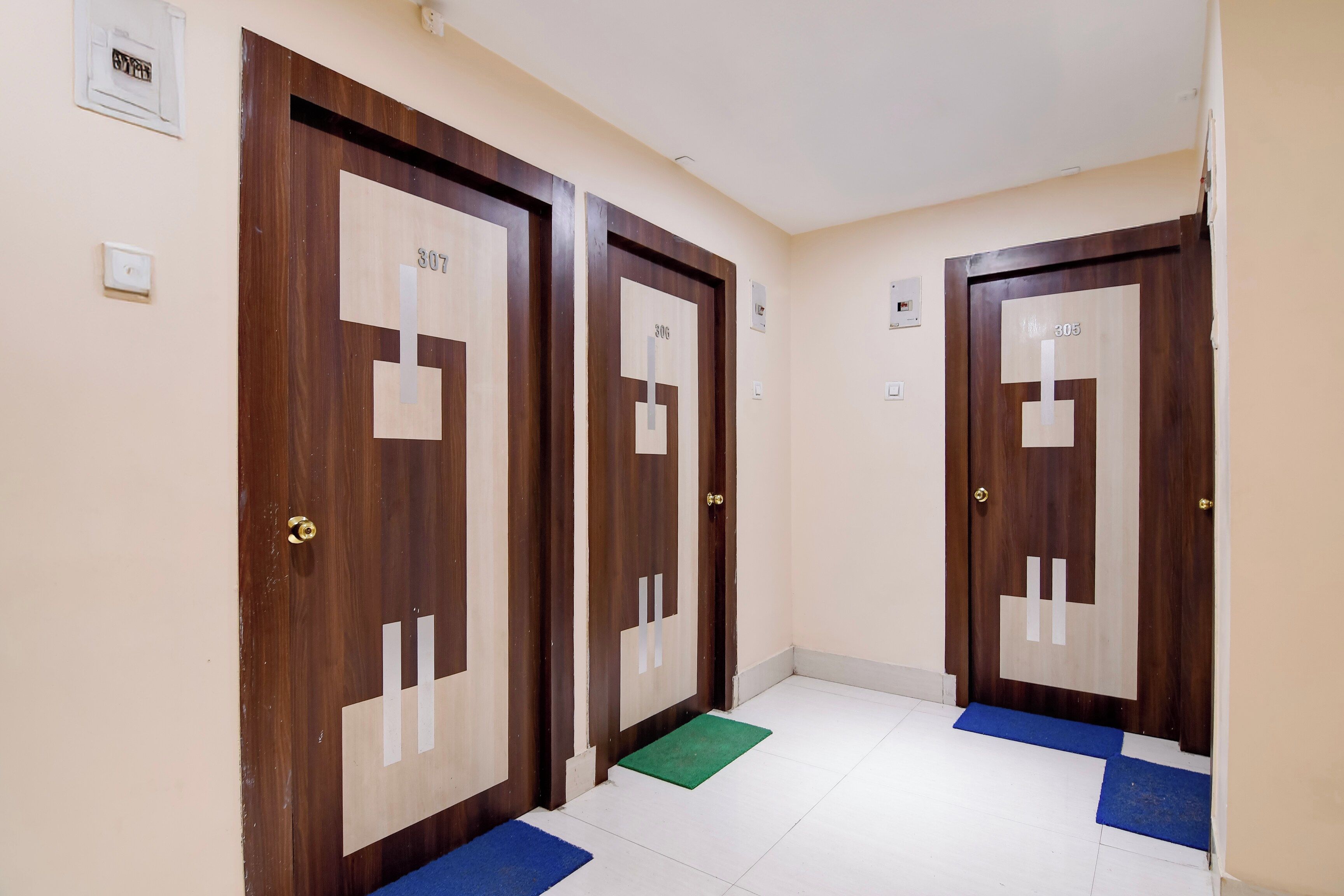 A hallway with three wooden doors, each marked with a number.