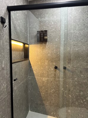 A modern bathroom with a glass enclosure, a heated floor, and a wall-mounted towel rack. - New Listing (Rio de Janeiro)