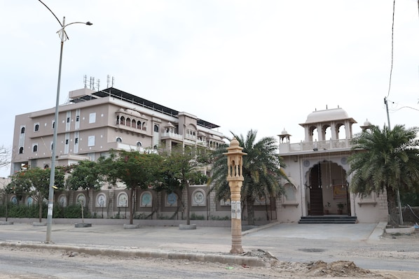 A building with a traditional architectural style, featuring arched windows and a central entrance with a decorative canopy.