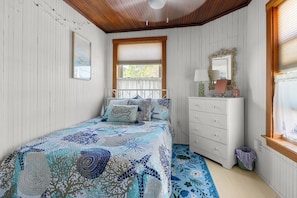 A bedroom with a bed, dresser, and a window with blinds. - Perfect spacious and sunsoaked 4-bedroom house near beach in Old Orchard Beach (Old Orchard Beach)