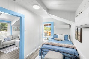 A bedroom with a bed, a window, a sofa, and a mirror. - Private 1BR Guest Suite with Deck & Full Kitchen (Abilene)