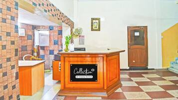 A reception desk with a sign reading 'Collection Company-Serviced'.