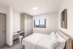 A bedroom with a bed, a desk, a chair, and a window with a view. - Villa Galazio - Three Bedroom Villa, Sleeps 6 (Argaka)