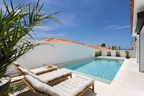 A rooftop pool with lounge chairs and potted plants. - New Listing (Callao Salvaje)