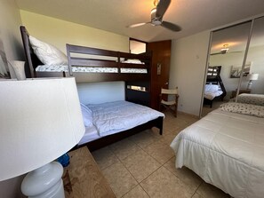 A room with bunk beds, a chair, a desk, and a mirror. - Beachfront apartment in Luquillo, Puerto Rico!! (Luquillo)