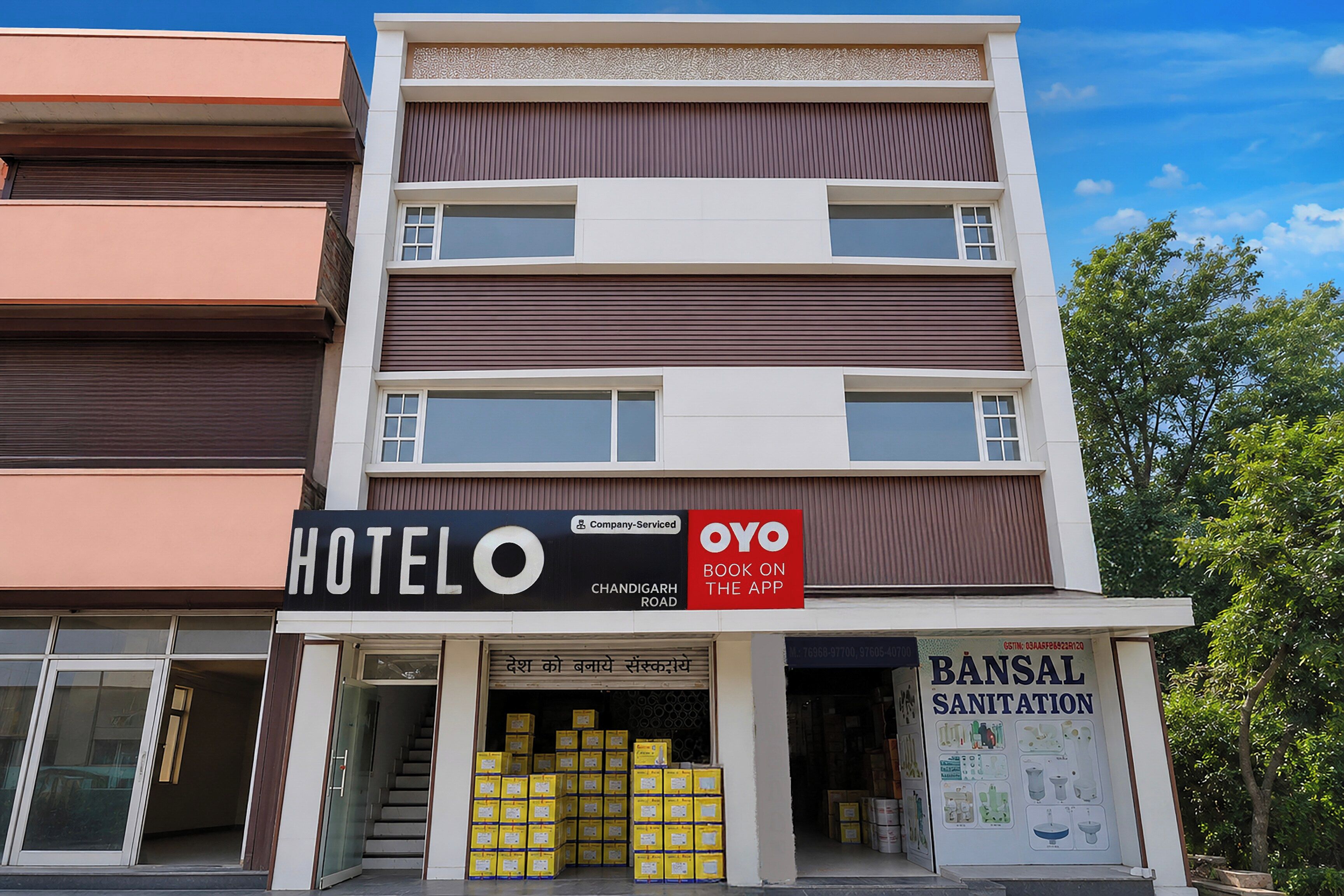 A hotel with a sign indicating it's a company service and an app booking option.