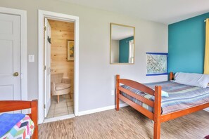 A bedroom with a wooden bed, a chair, a door, and a mirror. - 8Br 7Bath Sleeps 25+ Game hot tube 3 Min to MT (Hunter)