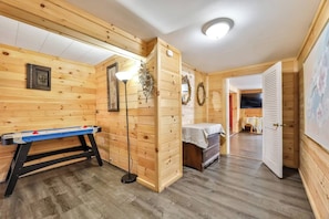 A wooden interior with a billiards table, a lamp, and a small table with a white cloth. - 8Br 7Bath Sleeps 25+ Game hot tube 3 Min to MT (Hunter)