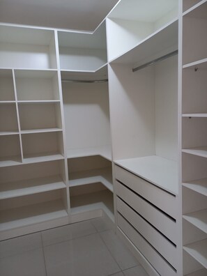 A walk-in closet with multiple shelves and drawers. - New Listing (Curitiba)