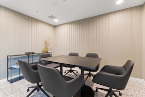 A conference room with a rectangular table, six chairs, a glass display unit, and a plant. - Elegant High-Floor 3BR with Skyline Views (Brisbane City)