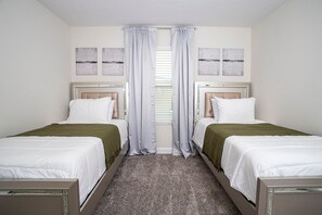 A double room with two beds, a carpeted floor, and a window with blinds. - NEW 5BR Private Pool  Lazy River   Resort 8955 (Kissimmee)