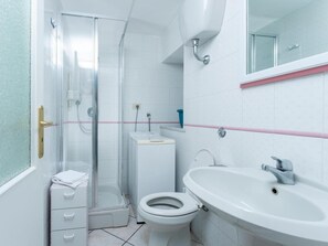 A bathroom with a glass-enclosed shower, a toilet, a sink, and a mirror. - A corner of paradise in Anacapri with a private sea-view sun terrace (Anacapri)