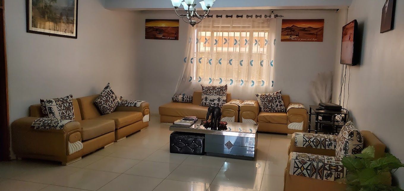 A living room with two sofas, a coffee table, and a television.