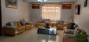 A living room with two sofas, a coffee table, and a television.