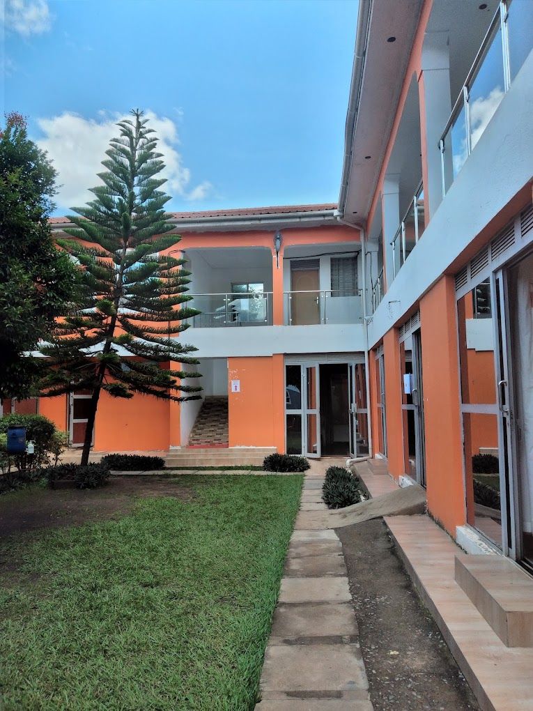 A building with a modern design, featuring a central staircase leading to an upper level.