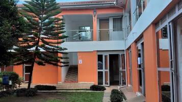 A building with a modern design, featuring a central staircase leading to an upper level.