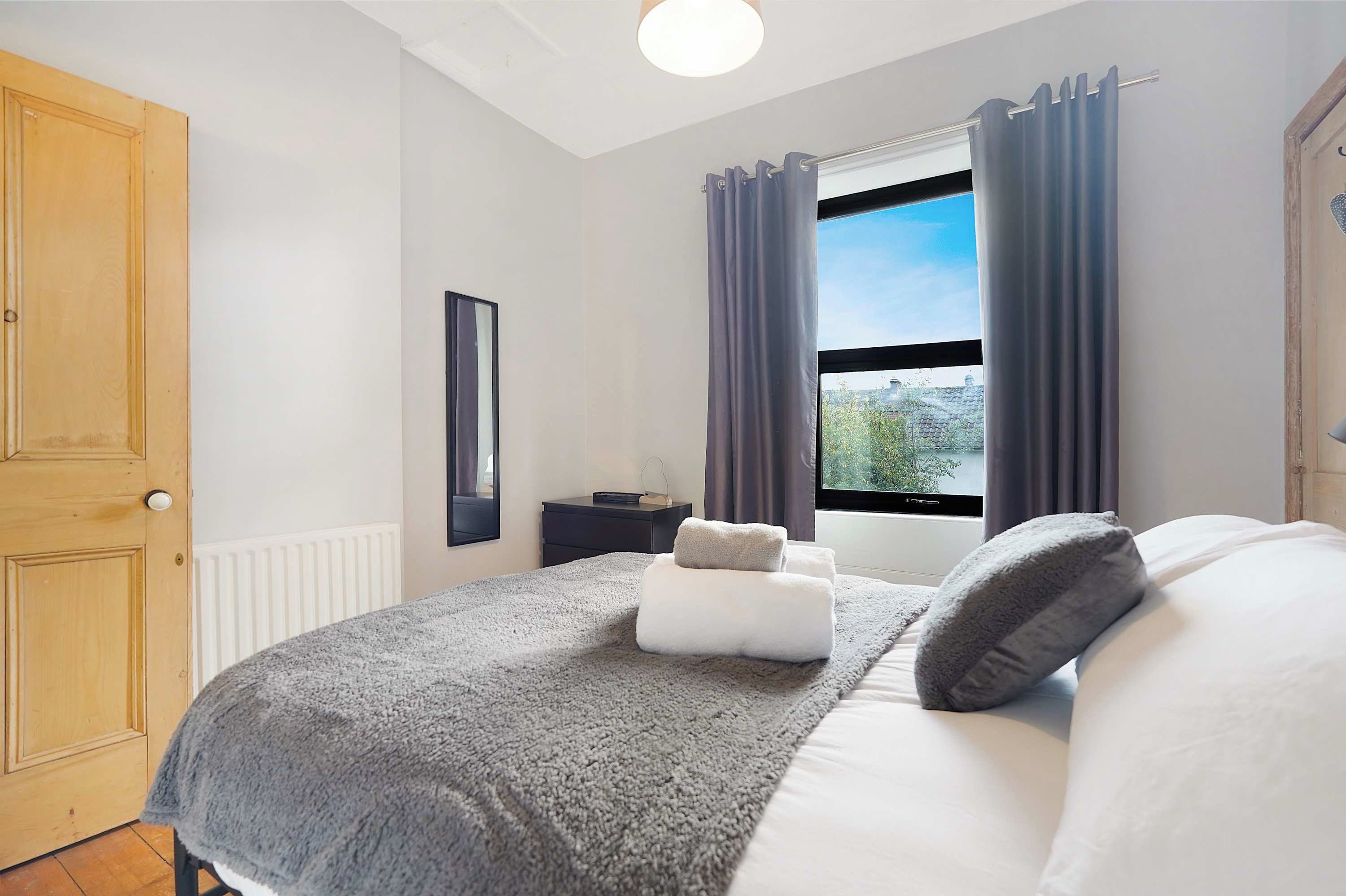 Unwind in the double bedroom, with a comfortable bed and bedside table for your essentials. Built-in storage and hangers provide room to unpack and enjoy a peaceful, comfortable space to rest and recharge.