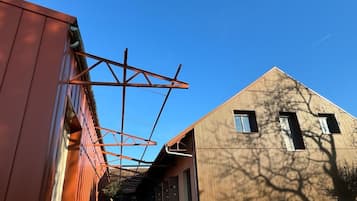 A building with a sloped roof and a metal structure extending from the side.