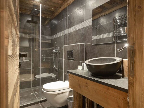 A modern bathroom with a glass-enclosed shower, a wooden vanity, and a large vessel sink. - Mountain chalet ski-in/ski-out - 8 guests (Courchevel)