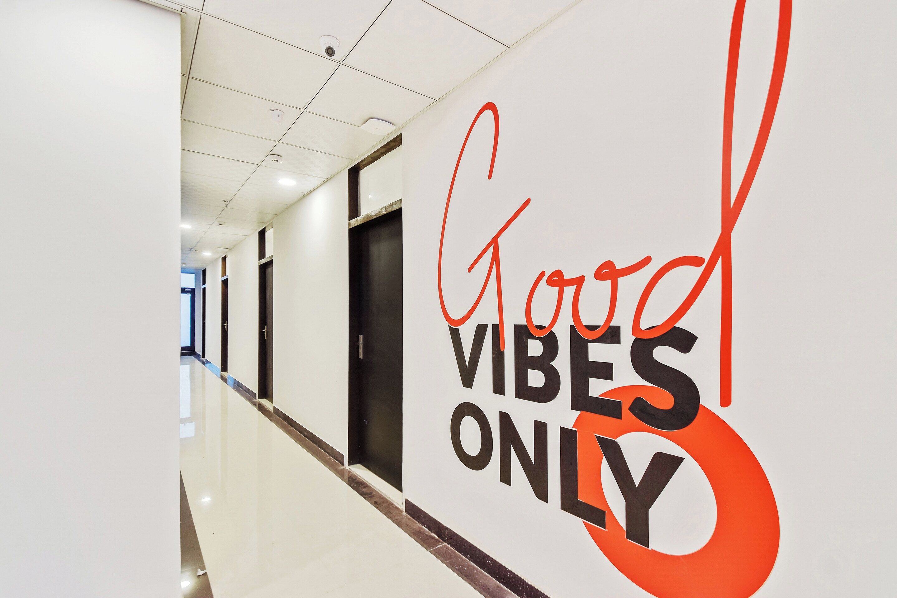 A hallway with a sign that reads 'Good Vibes Only'.