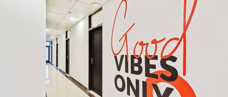 A hallway with a sign that reads 'Good Vibes Only'.