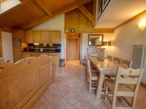 A wooden interior with a kitchen, dining area, and a large mirror. - Cozy duplex with parking - 8 guests (Samoëns)